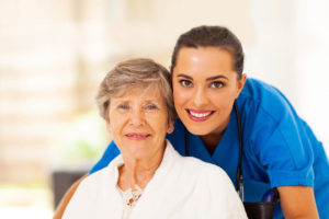 A woman and an older person smiling for the camera.